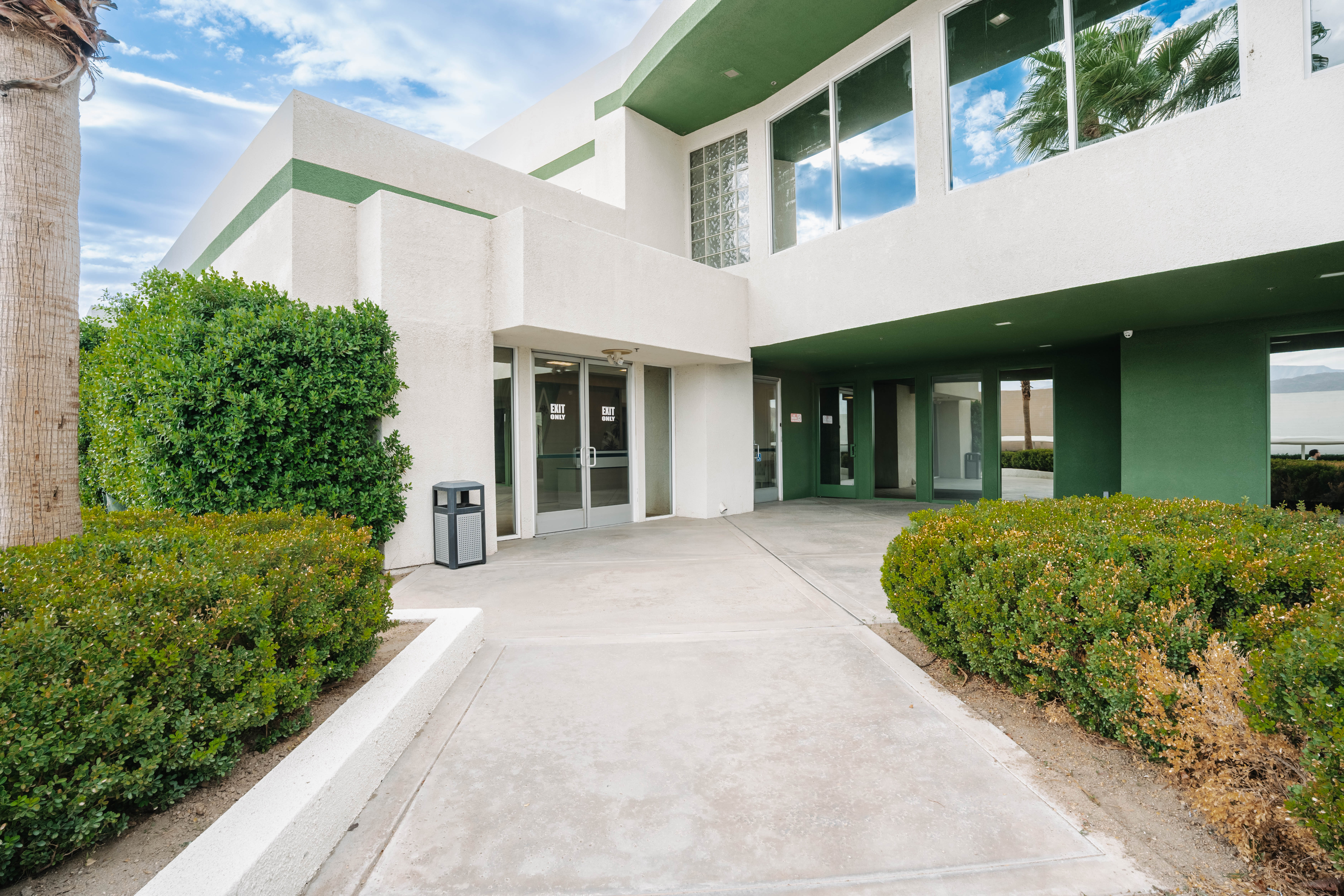 Building entrance walkway with landscaping